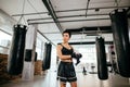 Side view shot of wonderful slender female looking away at gym