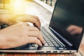 Side view shot of working at cafe with laptop man writing a blog. male hands on the keyboard Royalty Free Stock Photo