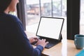 Side View shot of young business woman working with mockup white screen laptop computer at cafe. clipping path Royalty Free Stock Photo