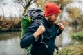 Side view shot of young hiker male hiking in mountains with travel backpack. Traveler bearded man relaxing after mountaineering Royalty Free Stock Photo