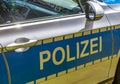 Side view from the silver, blue and yellow door of a German police car with the lettering Police Royalty Free Stock Photo