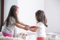 Side view of sisters fighting for toy guitar at home Royalty Free Stock Photo