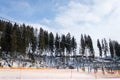 Side view of the snowy ski slope and working chairlift in the ski resort