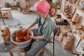 Female crafter making clay dishes in pottery room Royalty Free Stock Photo