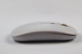Side view of a sleek white wireless computer mouse Royalty Free Stock Photo