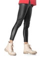 Beautiful female legs in black leggings and boots isolated on white background Royalty Free Stock Photo