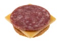 Side view of a slice of dry salami with gouda cheese on a round cracker Royalty Free Stock Photo