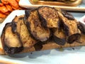 Side view of sliced fried eggplant. Appetizing brown sliced grilled eggplant on a piece of bread.