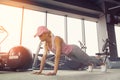 Side view of a slim fitnes young blonde girl doing planking exer