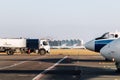 Side view small modern fuel tanker truck driving on airfield taxiway for aircraft refueling. Cistern lorry aviation Royalty Free Stock Photo