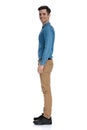 Side view of smart casual man waiting in line and smiling Royalty Free Stock Photo