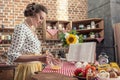 side view of smiling adult housewife whisking eggs for omelette