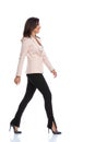 Side view of smiling businesswoman walking