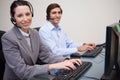 Side view of smiling call center agents at work Royalty Free Stock Photo