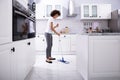 Happy Janitor Cleaning Floor With Mop Royalty Free Stock Photo