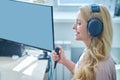 Joyous middle-aged blonde lady undergoing a hearing screening procedure