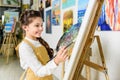 side view of smiling kid painting in workshop of Royalty Free Stock Photo