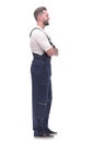 side view. smiling man in overalls looking forward to copy space