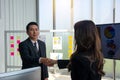 Side view smiling sales manager shaking woman hand in modern off