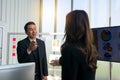 Side view smiling sales manager shaking woman hand in modern off