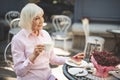 Delighted old woman sitting at table outside Royalty Free Stock Photo