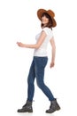 Side View Of Smiling Walking Young Woman In White T-Shirt And Hat Royalty Free Stock Photo
