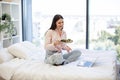 Smiling woman having video chat on wireless laptop while eating healthy salad. Royalty Free Stock Photo