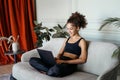 Young adult afro american woman using modern laptop