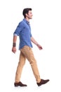 Side view of a smiling young casual man walking Royalty Free Stock Photo