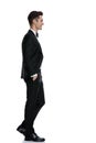 Side view of smiling young groom in tuxedo walking Royalty Free Stock Photo