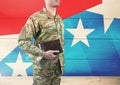 Side view of soldier holding a book in front of american flag Royalty Free Stock Photo