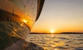 Side view Speeding fishing motor boat with drops of water. Blue ocean sea water wave reflections at the sunset. Motor boat in the