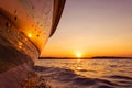 Side view Speeding fishing motor boat with drops of water. Blue ocean sea water wave reflections at the sunset. Motor boat in the Royalty Free Stock Photo