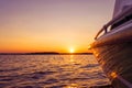 Side view Speeding fishing motor boat with drops of water. Blue ocean sea water wave reflections at the sunset. Motor boat in the