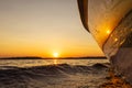 Side view Speeding fishing motor boat with drops of water. Blue ocean sea water wave reflections at the sunset. Motor boat in the Royalty Free Stock Photo