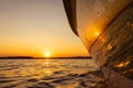 Side view Speeding fishing motor boat with drops of water. Blue ocean sea water wave reflections at the sunset. Motor boat in the Royalty Free Stock Photo