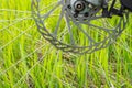 Side view of the spokes and brake disc of a mountain bike on a green grass background Royalty Free Stock Photo