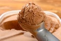 spoon taking out an ice cream ball from box of chocolate flavor ice cream close up Royalty Free Stock Photo