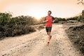 Sport man with ripped athletic and muscular legs running downhill off road in jogging training workout Royalty Free Stock Photo