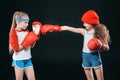 Side view of sportive girls pretending boxing isolated on black Royalty Free Stock Photo