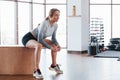 Side view. Sportive young woman have fitness day in the gym at morning time