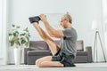 side view of sporty adult man stretching on yoga mat