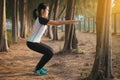 Side view of sporty athletic asian woman doing squatting,Beautiful female slim lady model practice balance and focused strong leg Royalty Free Stock Photo