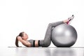 side view of sporty young woman exercising with fitness ball Royalty Free Stock Photo