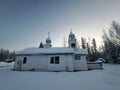 Side View of St Nicholas Russian Orthodox Church in Eklutna, Alaska on a Clear Winter Day, White Wooden Church Royalty Free Stock Photo