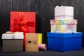 side view of a stack of colorful present boxes and a small i love you card at dark wooden background Royalty Free Stock Photo