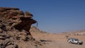 Side view of a stone man hanging from the rock above a shallow cave. The lone men are a mystery found in the northern Kaokoveld of