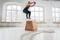 Side view of strong man doing a box jump exercise at workout gym Royalty Free Stock Photo