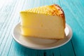Side view studio shoot of home made cheese cake on blue table Royalty Free Stock Photo