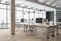 Side view on stylish eco interior design work places in open space office with white ceiling and wooden columns, parquet floor and Royalty Free Stock Photo